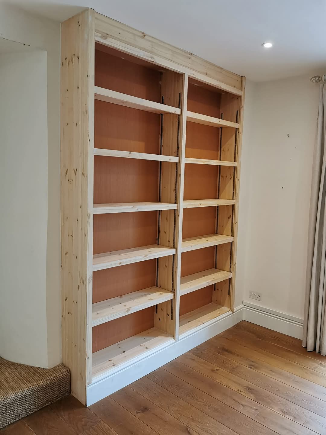 Bespoke built-in pine alcove bookshelves fitted by Dartmouth Handyman
